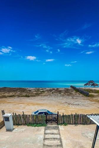 a wooden fence with a playground on the beach at Refugio, Casa de la Playa in Manaure