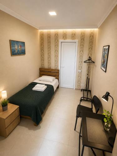 a bedroom with a bed and a table and a chair at Old Tbilisi in Itʼkhvisi