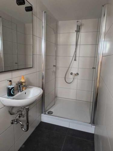 a white bathroom with a sink and a shower at Bruchsal Herz in Bruchsal