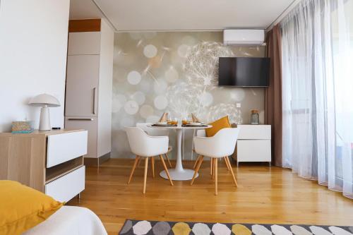 a kitchen and dining room with a table and chairs at BL Waterside 55 in Balatonlelle