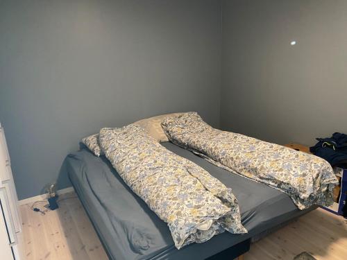 a bed with pillows on it in a room at Apartment in beautiful Stange in Stange