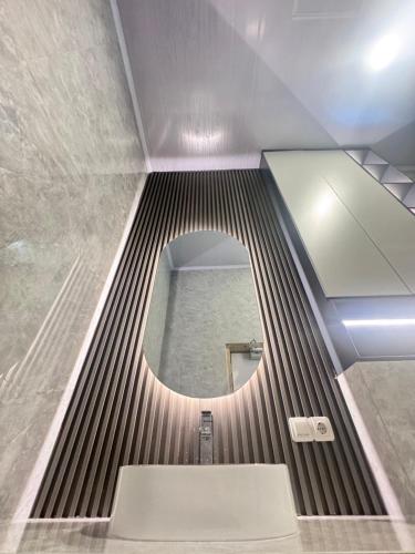 a bathroom with a mirror and a bath tub at Lombok Hidden Villa in Tetebatu
