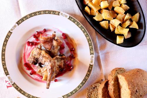 a plate of food with chicken and bread on a table at Guest House I Vicini di Cesare in Castelnuovo