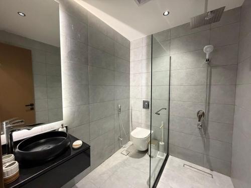 a bathroom with a shower and a sink and a toilet at Atrah Quiet Stylish Studio in Medina