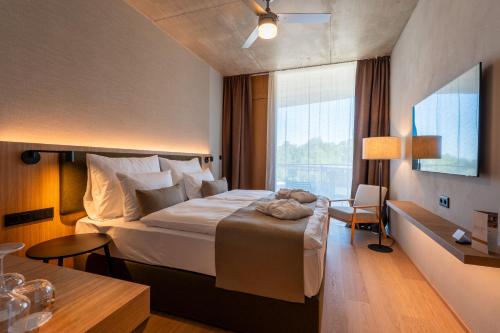 a hotel room with a large bed and a window at ARTEVINI Resort & Winery in Velké Pavlovice