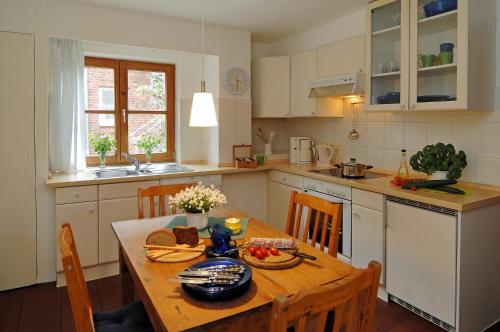 a kitchen with a wooden table with food on it at Ferienhof Trapp in Ellringen