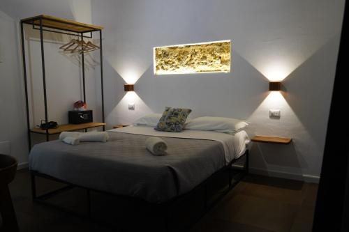 a bedroom with a bed with two lamps on it at L'antica Dimora Fronte Mare in Finale