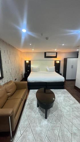 a living room with a bed and a couch at Novatel Radisson Lekki in Lekki