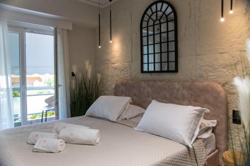 a bedroom with a bed with towels on it at CityView Luxury Suite in Alexandroupoli