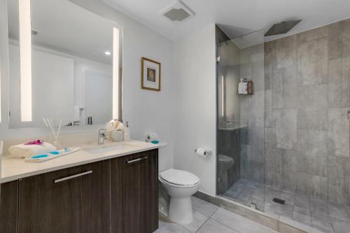 a bathroom with a shower and a toilet and a sink at Miami Downtown Bayside Balcony Studio in Miami
