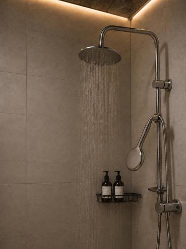 a shower with a shower head in a bathroom at Alis House 3 in Batumi
