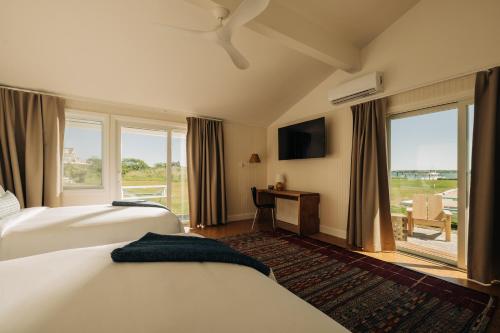 a hotel room with two beds and a large window at Barlume Beach in Montauk