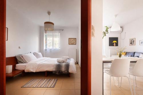 a bedroom with a bed and a table and chairs at Spartan Gem Apartment in Sparta
