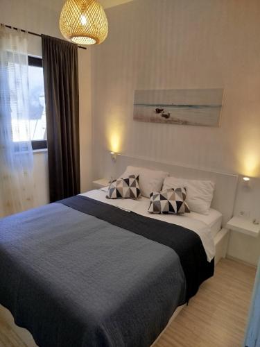 a bedroom with a large bed with two pillows on it at Marko in Fažana