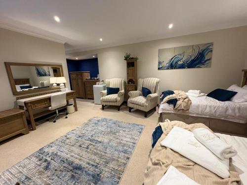 a bedroom with two beds and a desk and a piano at Marble on 8 in Rustenburg