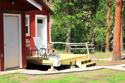 a porch of a house with a bench and a table at Grizzly Gulch Cabin Historic in Keystone