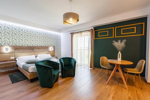 a bedroom with a bed and a table and chairs at Halanus Agriexperience in Alanno