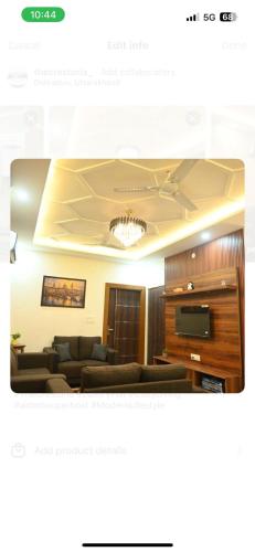 a living room with a couch and a tv at Thecrestoria in Dehradun