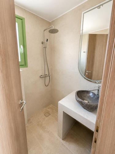 a bathroom with a sink and a mirror at Villa Sofia Traditional Cycladic living in Kampos Paros