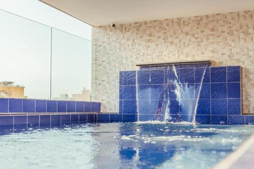 a water fountain in the middle of a building at Hotel Boutique ADAZ in Santa Marta