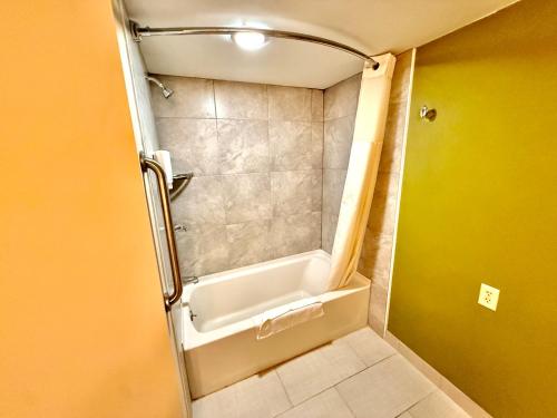 a bathroom with a shower with a bath tub at Sleep Inn & Suites Niantic North in Niantic