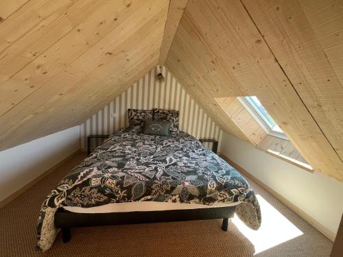 a bedroom with a bed in a attic at Ty glaz in Plouguerneau
