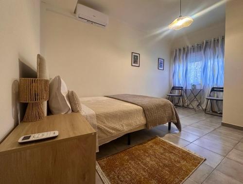 a bedroom with a bed and a table in a room at O Jardim Mágico in Teixoso