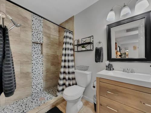 a bathroom with a toilet and a sink and a shower at Silk Oak Tempe in Tempe