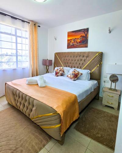 a bedroom with a large bed in a room at The Royals in Tatu City