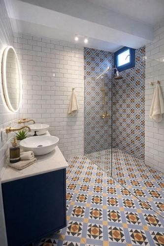 a bathroom with a sink and a glass shower at Villa ATLAS relax in Prinos