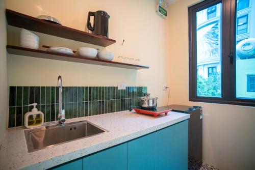a kitchen with a sink and a window at DoDo Apartments in Hanoi