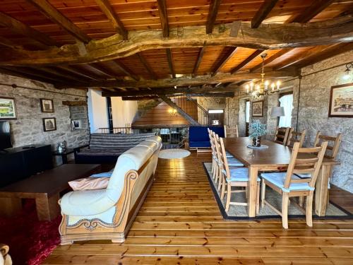 a living room with a couch and a table at A Casa do Ferreiro in Cerdedo
