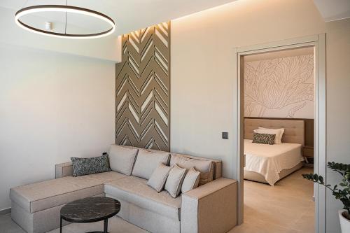 a living room with a couch and a bed at Infinity Palm Villa in Stavros