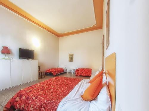 a bedroom with a large bed with red pillows at Villa Gini in Pisa