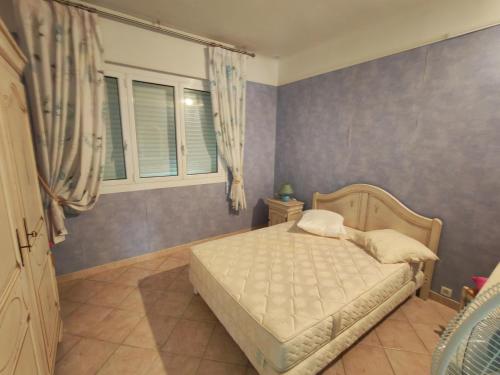 a bedroom with a bed and a window at Villa du Capelan - BANDOL in Bandol