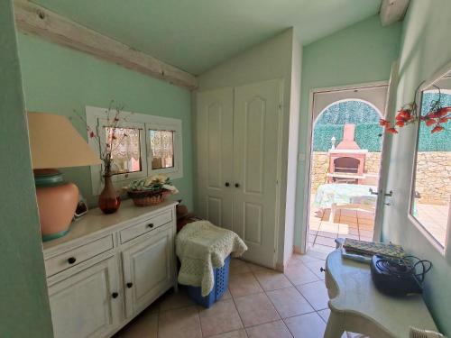 a room with a dresser with a mirror and a door at Villa du Capelan - BANDOL in Bandol