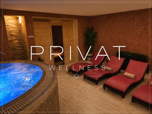 a hotel room with a swimming pool and a sign that reads private wellness at Wellness Pension 7 in Harrachov