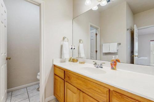 a bathroom with a sink and a large mirror at Scenic Riverfront Home with Boat Access, Private Pool/Hot Tub - Close to Shopping in Lago Vista