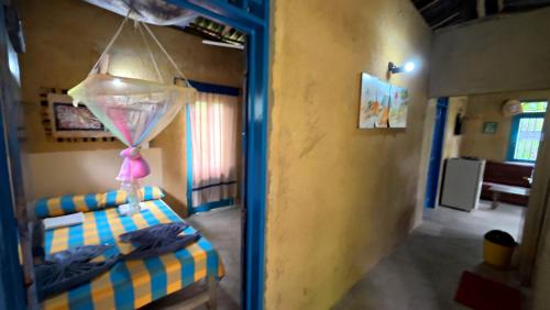 a room with a bedroom with a bed and a mirror at Achinthya Nature Resort in Avissawella