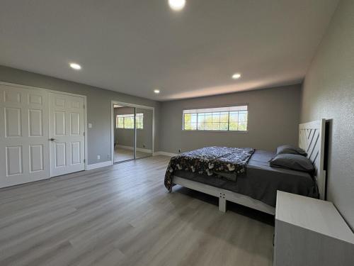 a bedroom with a bed in a room with wooden floors at Vintage Vineyard Estate in Oakley
