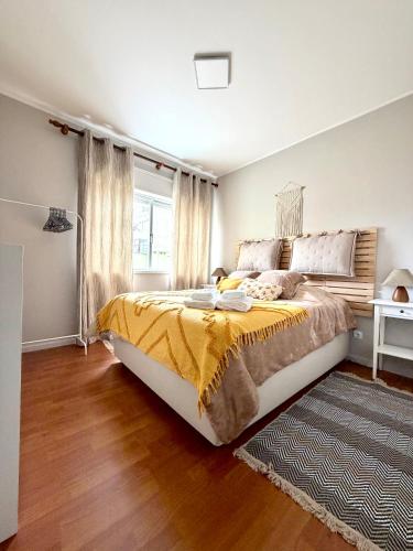 a bedroom with a large bed and a window at DaKing in Vila do Conde