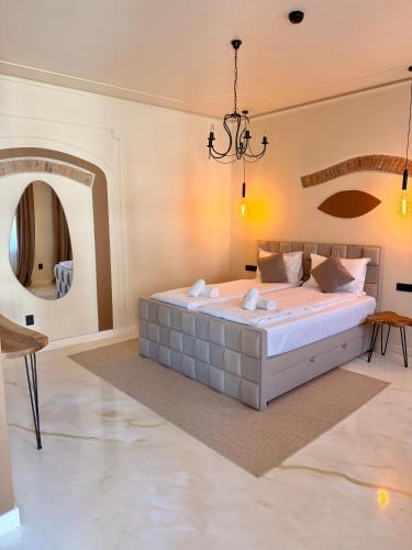 a bedroom with a large bed and a chandelier at Demiani House in Sibiu