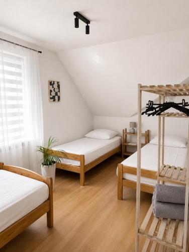 a bedroom with two bunk beds and a ladder at APARTMENT ON THE ROAD S-61 in Szypliszki
