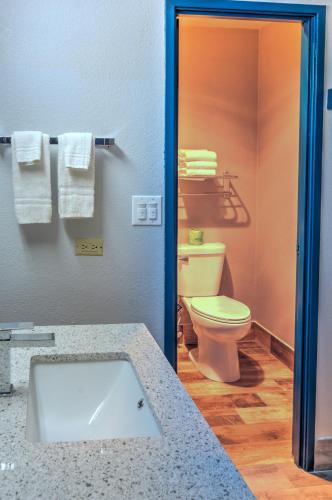 a bathroom with a sink and a toilet and towels at Motel 6-Libertyville, IL in Libertyville