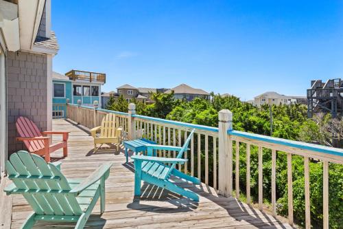 a deck with chairs and tables on a house at 8396 - White Dune in Avon