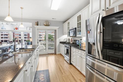 a kitchen with white cabinets and stainless steel appliances at SBC1001 - Sweet Retreat in Manteo