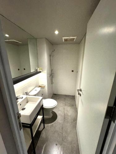 a bathroom with a toilet and a sink at Comfortable House - Tabebuya BSD in Tegal