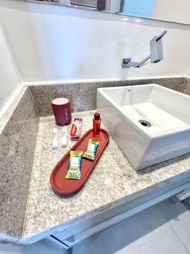 a bathroom counter with a sink and a tray at Infinity 1206 - 2 Quartos a Passos da Praia com Garagem in Vila Velha