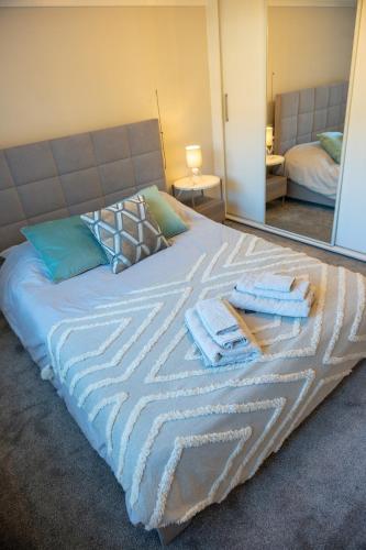 a bed with towels on it in a bedroom at Aughamore Home in CBG