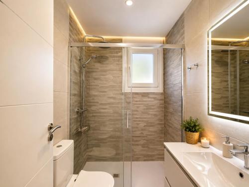 a bathroom with a shower and a toilet and a sink at Holibai Portaliña, Mar y Montaña, Baiona in Baiona